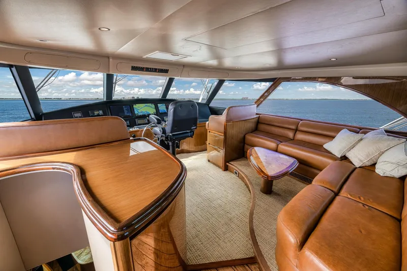 Slide: The Image of Luxurious interior of 2012 Viking 70 Enclosed Bridge yacht with leather seating and ocean view. - 63