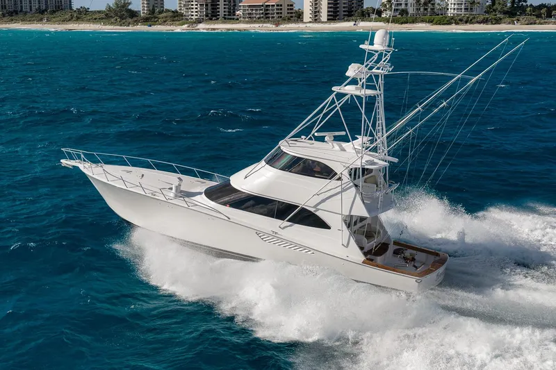 Slide: The Image of 2012 Viking 70 Enclosed Bridge yacht cruising on blue ocean near coastline. - 7