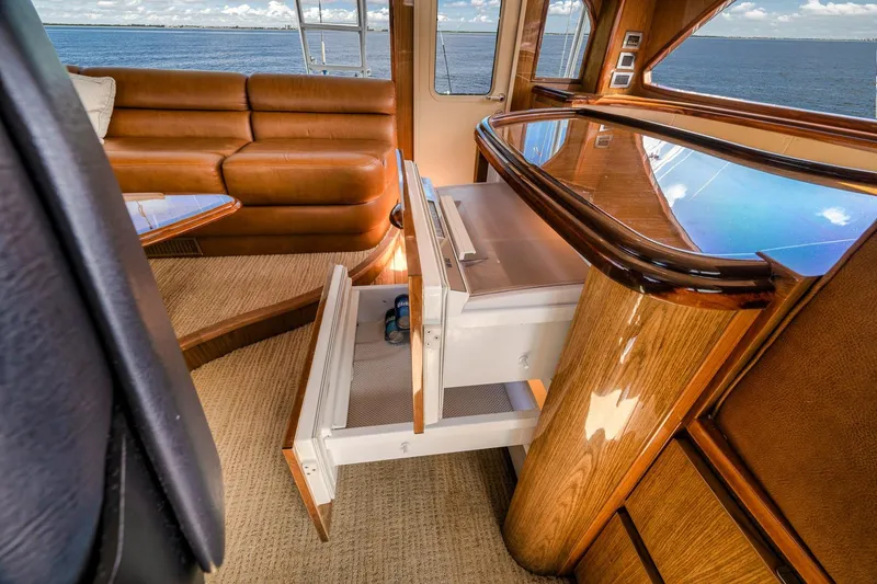 Slide: The Image of Luxurious interior of 2012 Viking 70 Enclosed Bridge yacht with leather seating and ocean view. - 71