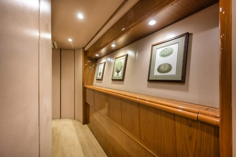 Slide: The Image of Luxurious hallway interior of 2012 Viking 70 Enclosed Bridge yacht with framed artwork. - 78