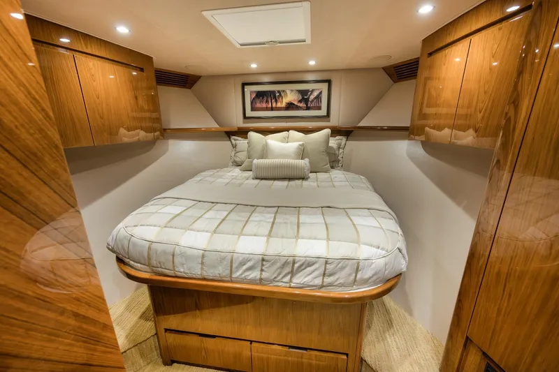 Slide: The Image of Luxurious bedroom interior of 2012 Viking 70 Enclosed Bridge yacht with elegant wood finishes. - 82