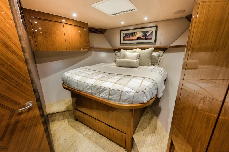Slide: The Image of Luxurious bedroom interior of 2012 Viking 70 Enclosed Bridge yacht with wood finishes. - 84
