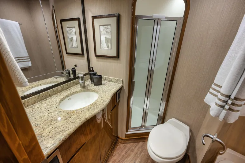 Slide: The Image of Luxurious bathroom in 2012 Viking 70 Enclosed Bridge yacht with granite countertop and shower. - 86