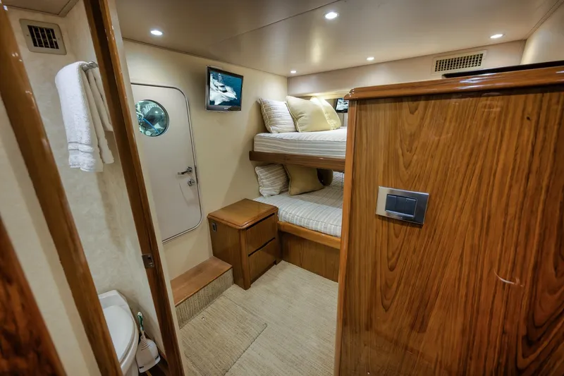 Slide: The Image of Luxurious cabin interior of 2012 Viking 70 Enclosed Bridge yacht with bunk beds. - 88