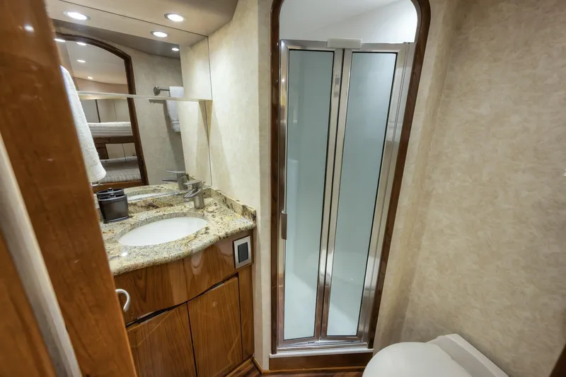 Slide: The Image of Luxurious bathroom in 2012 Viking 70 Enclosed Bridge yacht with granite countertop and shower. - 91