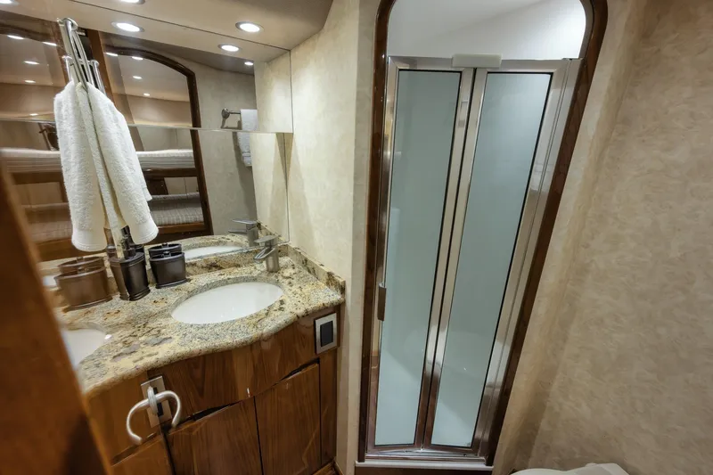 Slide: The Image of Luxurious bathroom in 2012 Viking 70 Enclosed Bridge yacht with granite countertop and shower. - 92