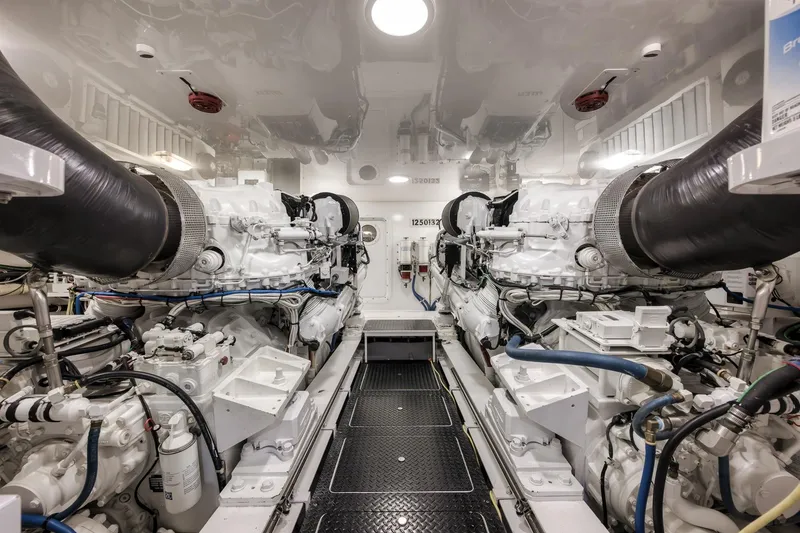 Slide: The Image of Engine room of 2012 Viking 70 Enclosed Bridge yacht, showcasing dual engines and mechanical systems. - 93