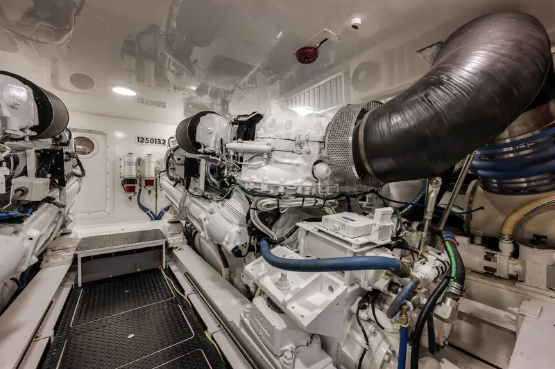 Slide: The Image of Engine room of 2012 Viking 70 Enclosed Bridge yacht, showcasing powerful machinery and components. - 95