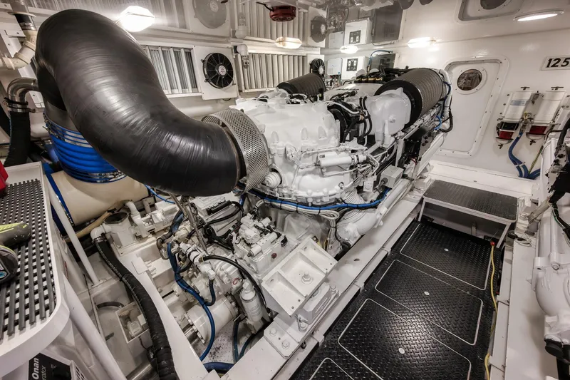 Slide: The Image of Engine room of 2012 Viking 70 Enclosed Bridge yacht, showcasing powerful machinery and components. - 96