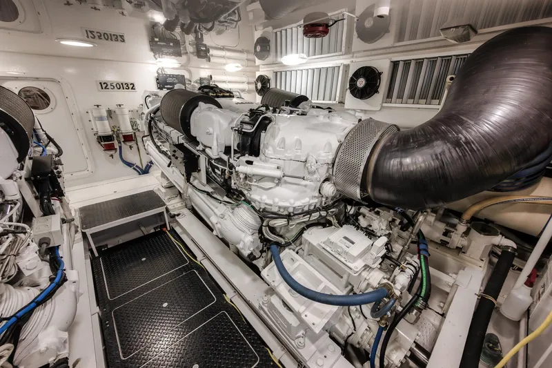 Slide: The Image of Engine room of 2012 Viking 70 Enclosed Bridge yacht, showcasing powerful machinery and components. - 97