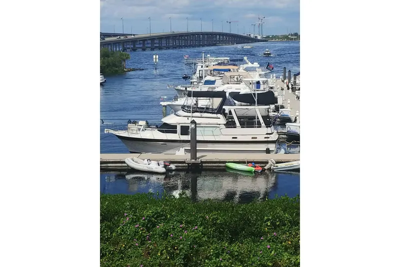 Slide: The Image of 1984 Kha Shing 40 Spindrift yacht docked at marina with bridge in background. - 1