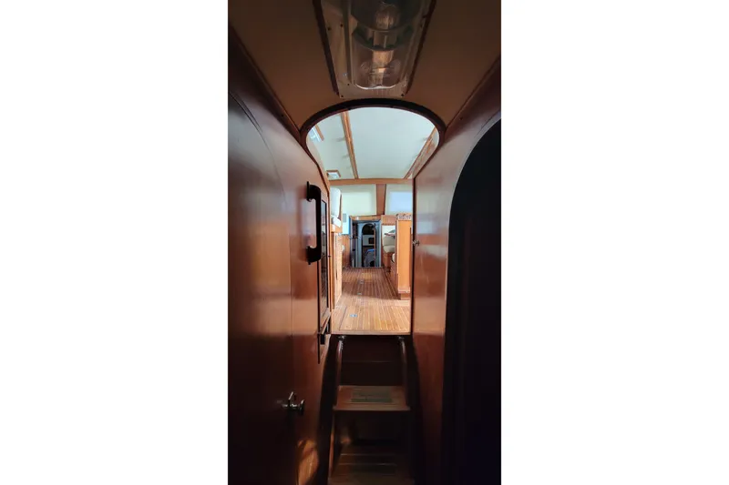 Slide: The Image of 1984 Kha Shing 40 Spindrift yacht interior with helm, life preserver, and seating area. - 13