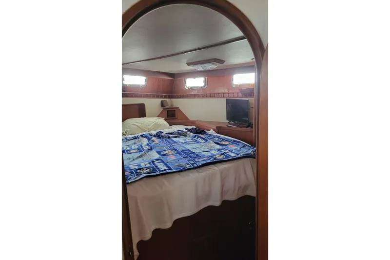 Slide: The Image of 1984 Kha Shing 40 Spindrift yacht interior with wicker chair and helm station. - 14