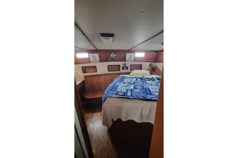 Slide: The Image of 1984 Kha Shing 40 Spindrift yacht helm with steering wheel and seating area. - 15