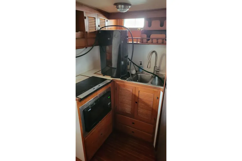 Slide: The Image of 1984 Kha Shing 40 Spindrift yacht helm with wooden finish and navigation equipment. - 18