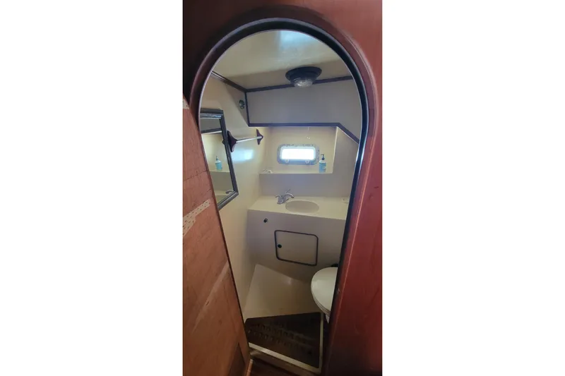 Slide: The Image of Interior of 1984 Kha Shing 40 Spindrift with wooden helm and cushioned seating. - 19