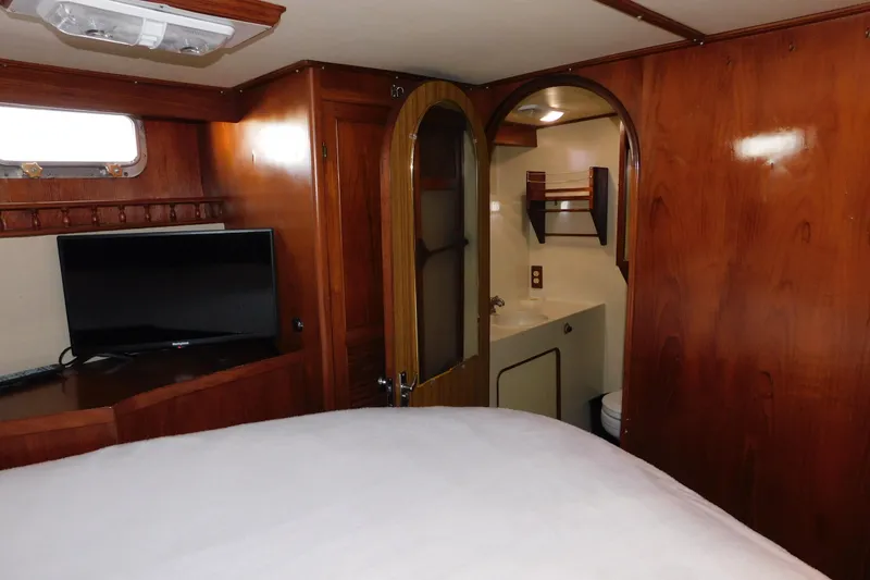 Slide: The Image of Cozy cabin interior of 1984 Kha Shing 40 Spindrift yacht with wood paneling and TV. - 33