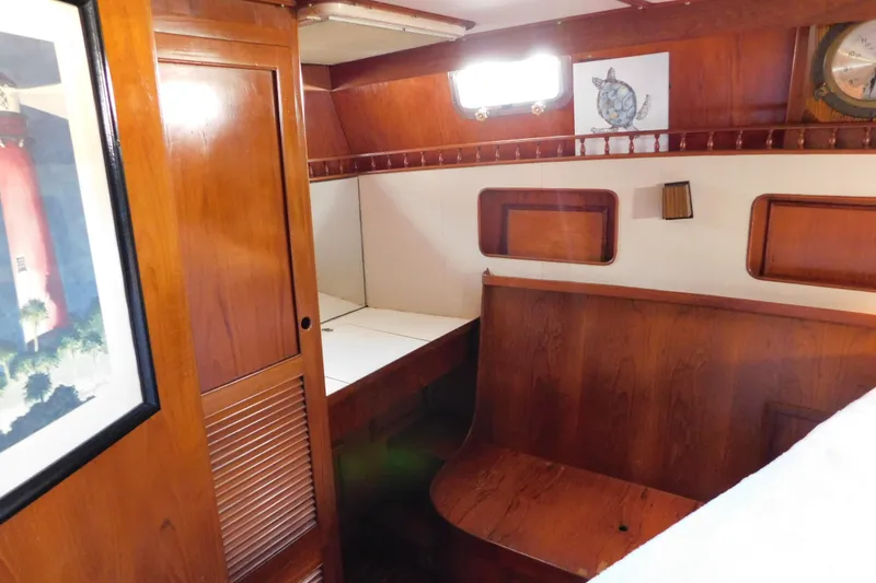 Slide: The Image of 1984 Kha Shing 40 Spindrift yacht interior with wooden cabinetry and seating area. - 36