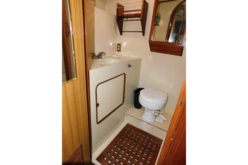 Slide: The Image of 1984 Kha Shing 40 Spindrift yacht bathroom with sink, toilet, and wooden accents. - 38