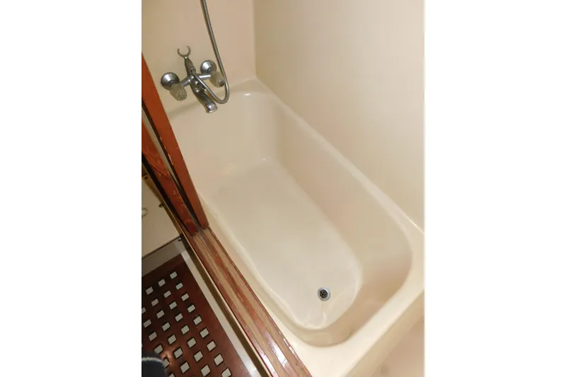 Slide: The Image of Bathtub in 1984 Kha Shing 40 Spindrift yacht, featuring classic fixtures and wooden accents. - 39