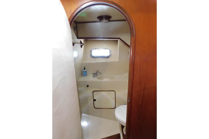 Slide: The Image of 1984 Kha Shing 40 Spindrift yacht bathroom with sink, toilet, and porthole window. - 45