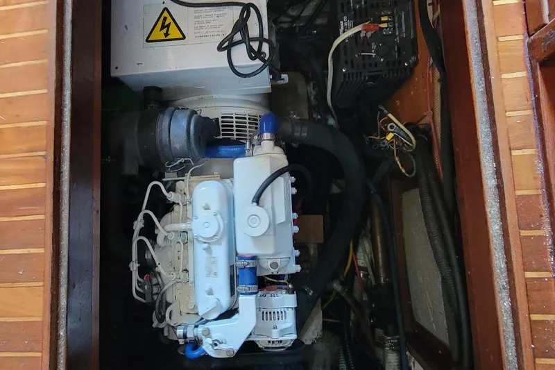 Slide: The Image of Engine compartment of 1984 Kha Shing 40 Spindrift boat, featuring electrical components. - 53