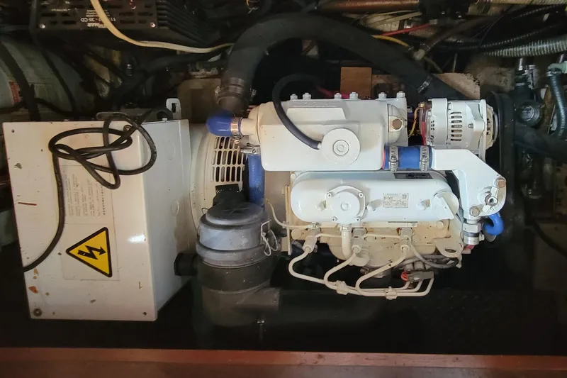 Slide: The Image of Engine room of 1984 Kha Shing 40 Spindrift yacht, featuring mechanical components. - 56