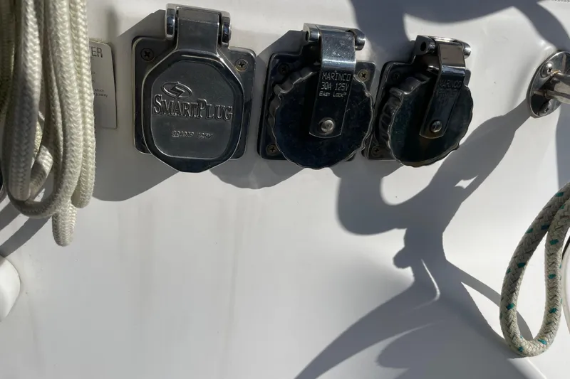 Slide: The Image of Open hatch on 1999 Hunter 460 sailboat, showing storage compartment with ropes. - 16