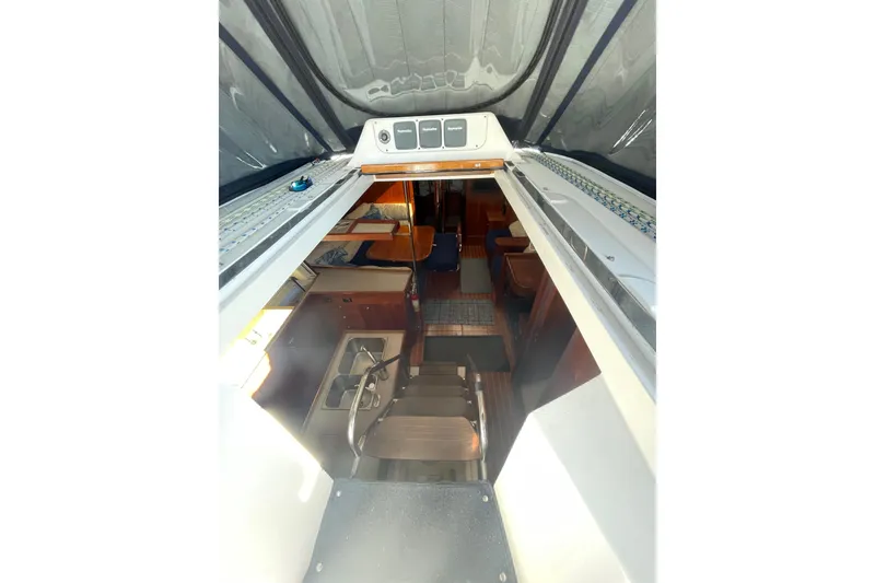 Slide: The Image of Storage compartment with coiled cables on a 1999 Hunter 460 boat. - 18