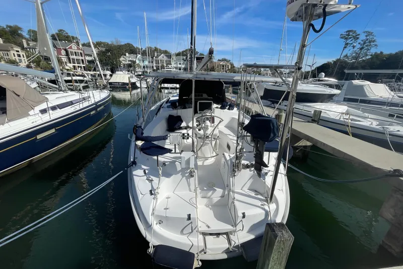 Slide: The Image of Sailboat docked at marina, 1999 Hunter 460 model, surrounded by palm trees. - 2