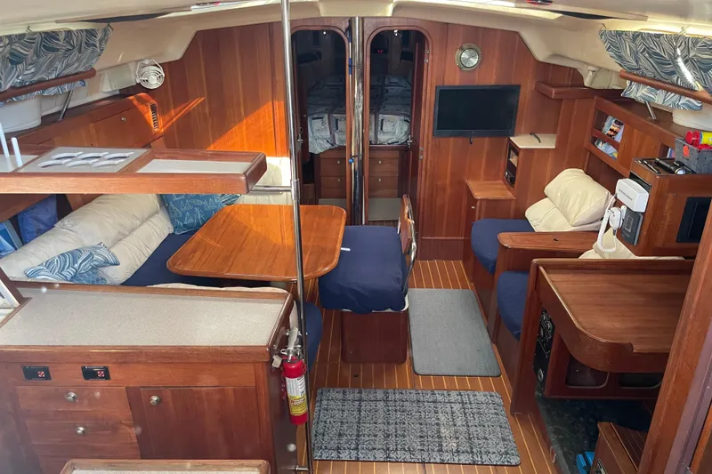 Slide: The Image of Storage compartment with coiled cables on a 1999 Hunter 460 boat. - 22