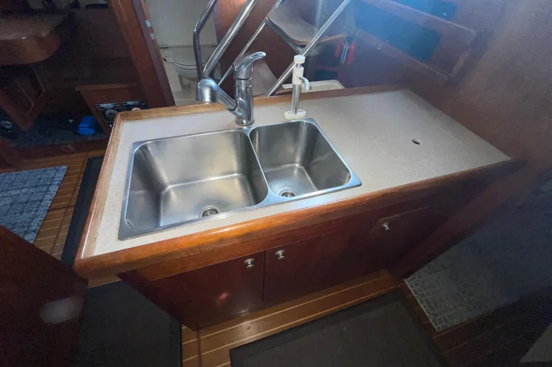 Slide: The Image of Cozy interior of a 1999 Hunter 460 sailboat with wood finish and seating area. - 27