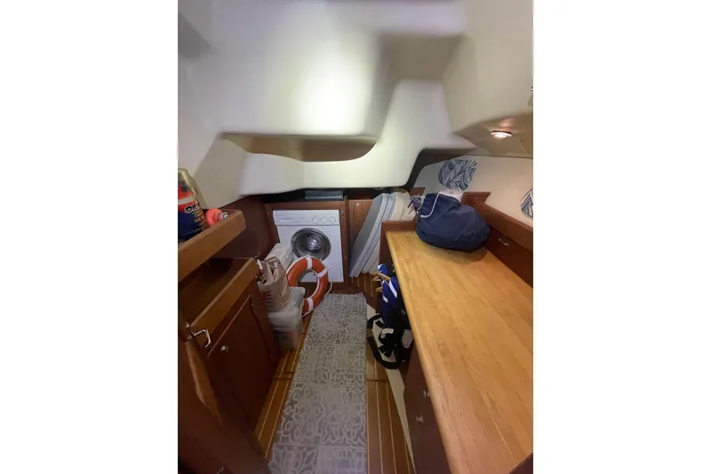 Slide: The Image of Interior of 1999 Hunter 460 yacht with cozy seating and wooden finishes. - 28