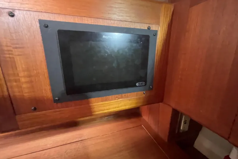 Slide: The Image of Cozy seating area in 1999 Hunter 460 yacht with bookshelves and communication equipment. - 30