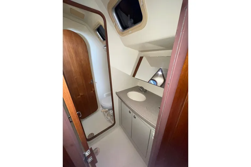 Slide: The Image of Electrical control panel of a 1999 Hunter 460 yacht, featuring various switches and meters. - 36