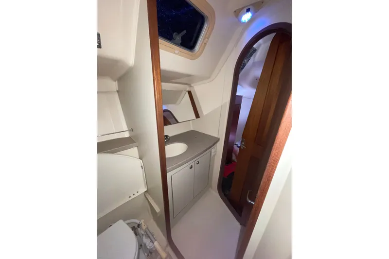 Slide: The Image of Control panel of a 1999 Hunter 460 boat with gauges and switches. - 37