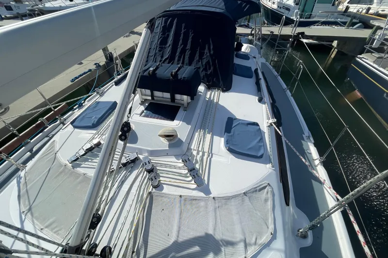 Slide: The Image of 1999 Hunter 460 sailboat on stands, blue and white hull, dockside maintenance. - 4