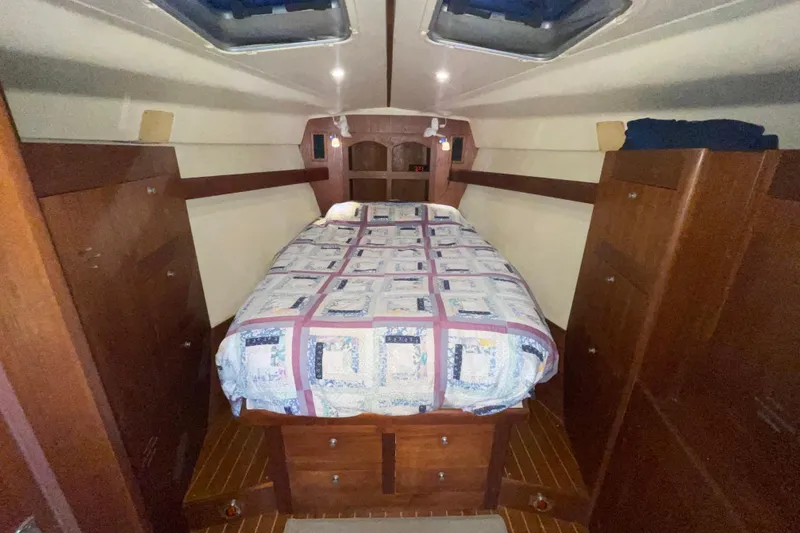 Slide: The Image of Cozy cabin interior of 1999 Hunter 460 sailboat with quilted bedspread. - 40
