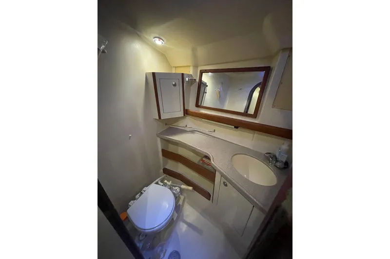 Slide: The Image of Bathroom interior of 1999 Hunter 460 sailboat with sink, mirror, and wooden door. - 42