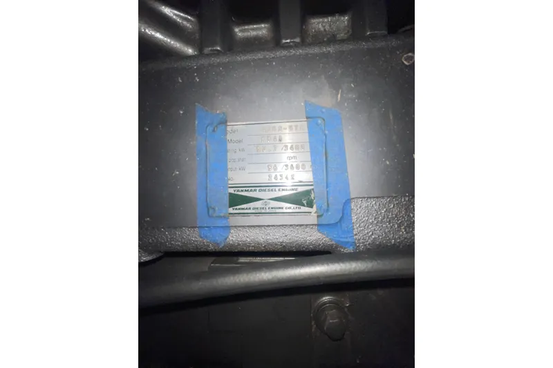 Slide: The Image of Close-up of a Hunter 460 engine plate, model year 1999, with blue tape. - 48