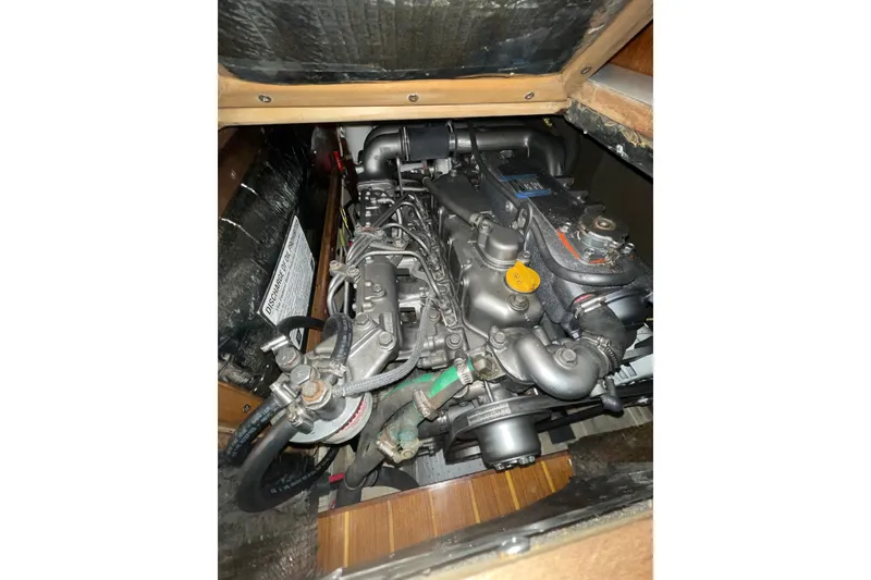 Slide: The Image of Engine compartment of a 1999 Hunter 460 sailboat, showcasing detailed mechanical components. - 50