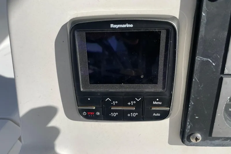 Slide: The Image of 1999 Hunter 460 sailboat docked in a marina, surrounded by other boats. - 7