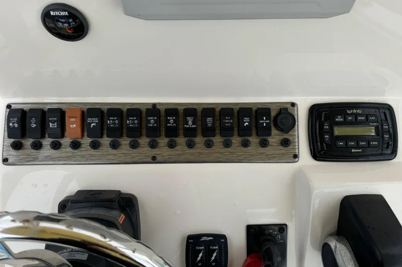 Slide: The Image of Control panel of a 2019 Sea Chaser 24 HFC boat with switches and a stereo system. - 11