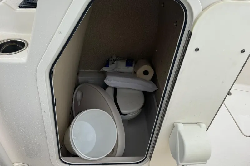 Slide: The Image of 2019 Sea Chaser 24 HFC boat interior with compact marine toilet. - 14
