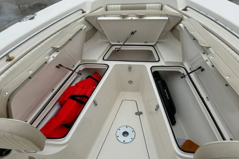 Slide: The Image of 2019 Sea Chaser 24 HFC boat interior storage compartments with safety equipment. - 17