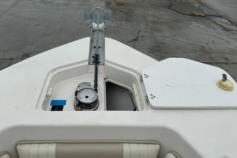 Slide: The Image of 2019 Sea Chaser 24 HFC boat anchor compartment with chain and winch. - 18
