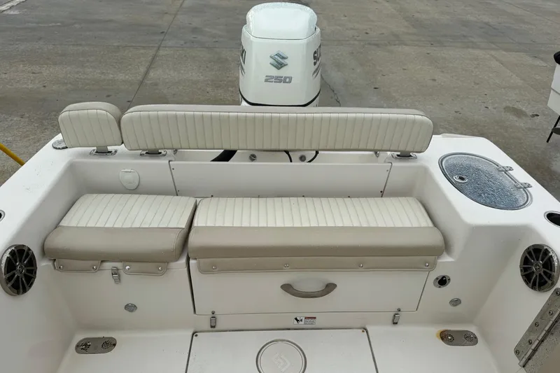 Slide: The Image of 2019 Sea Chaser 24 HFC boat interior with seating and Suzuki 250 outboard motor. - 2