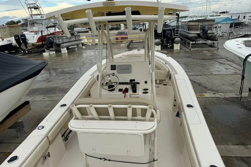 Slide: The Image of 2019 Sea Chaser 24 HFC boat at marina, featuring helm and seating area. - 21