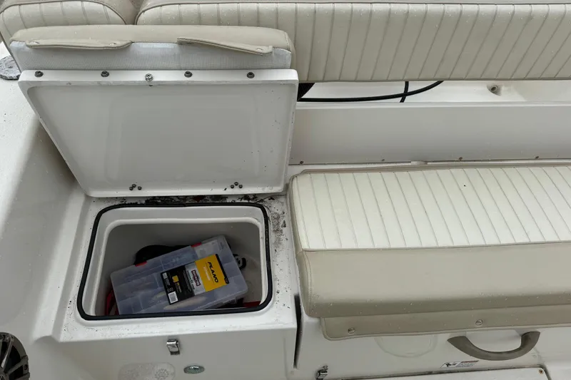 Slide: The Image of 2019 Sea Chaser 24 HFC boat storage compartment with tackle box inside. - 4