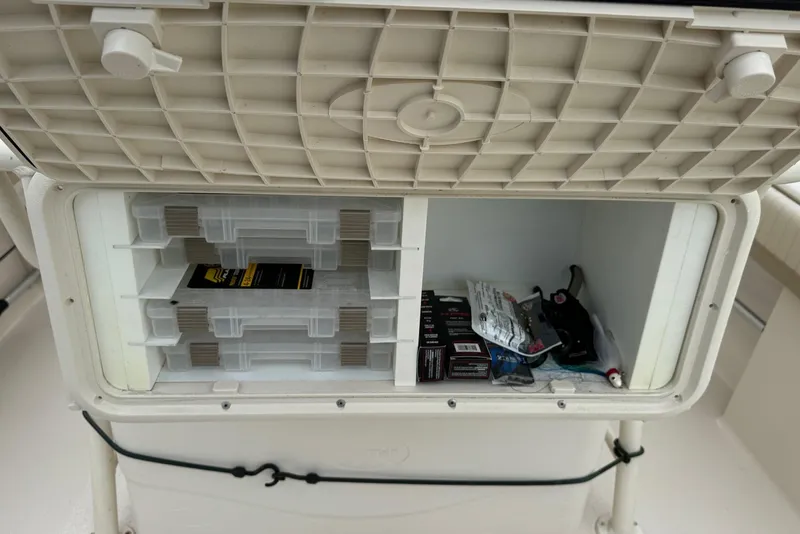 Slide: The Image of Storage compartment on a 2019 Sea Chaser 24 HFC boat with organized gear. - 8
